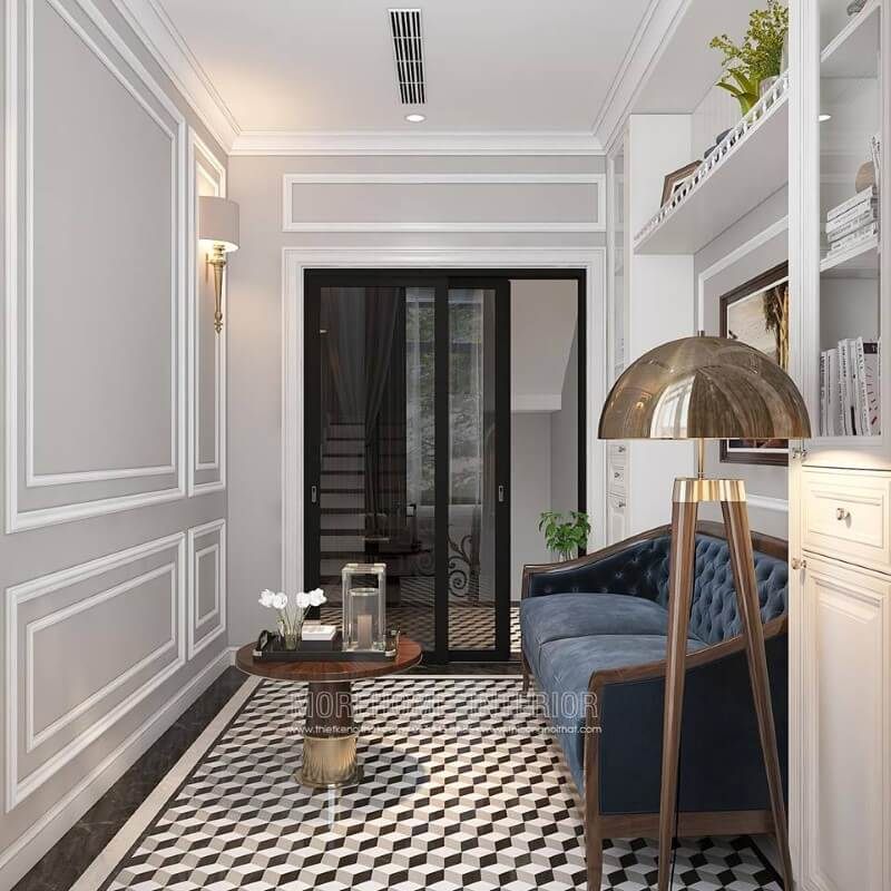 Gạch lát nền giả cổ, sofa đơn gỗ óc chó tân cổ điển bọc nệm xanh cùng tường trắng đơn sắc đã tạo nên không gian đẹp sang trọng, đáp ứng tối đa công năng cho phòng đọc sách.